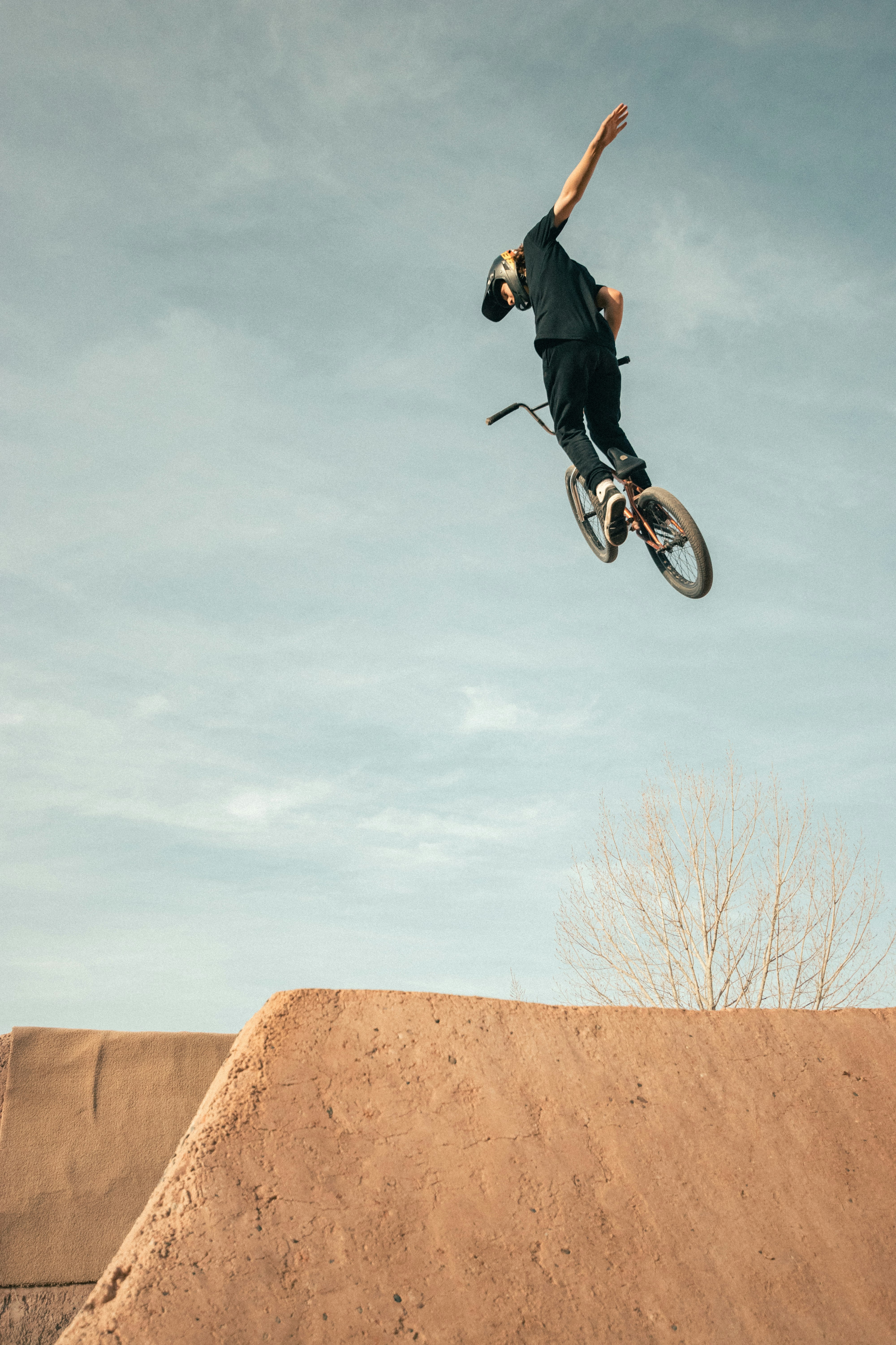 man in black jacket riding on bicycle during daytime